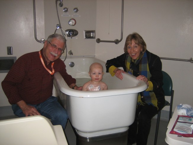 Mom & Dad giving Allistaire a bath